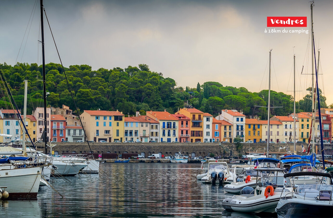 Vendres harbor with boats and colorful houses, a place to visit near Saint Pierre la Mer.