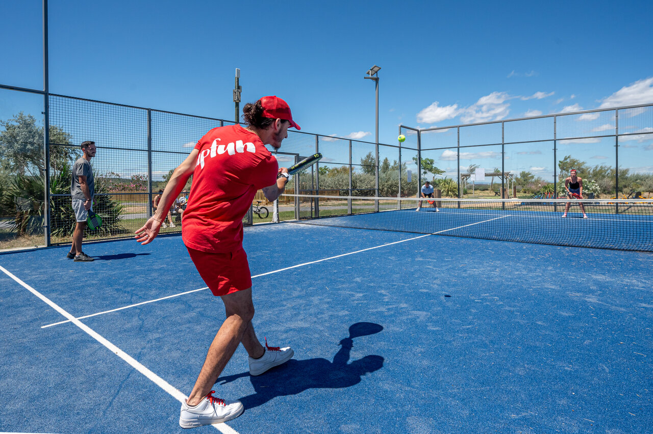 Blue padel court with players at camping CAPFUN Grande Cosse, Saint Pierre la Mer (11).