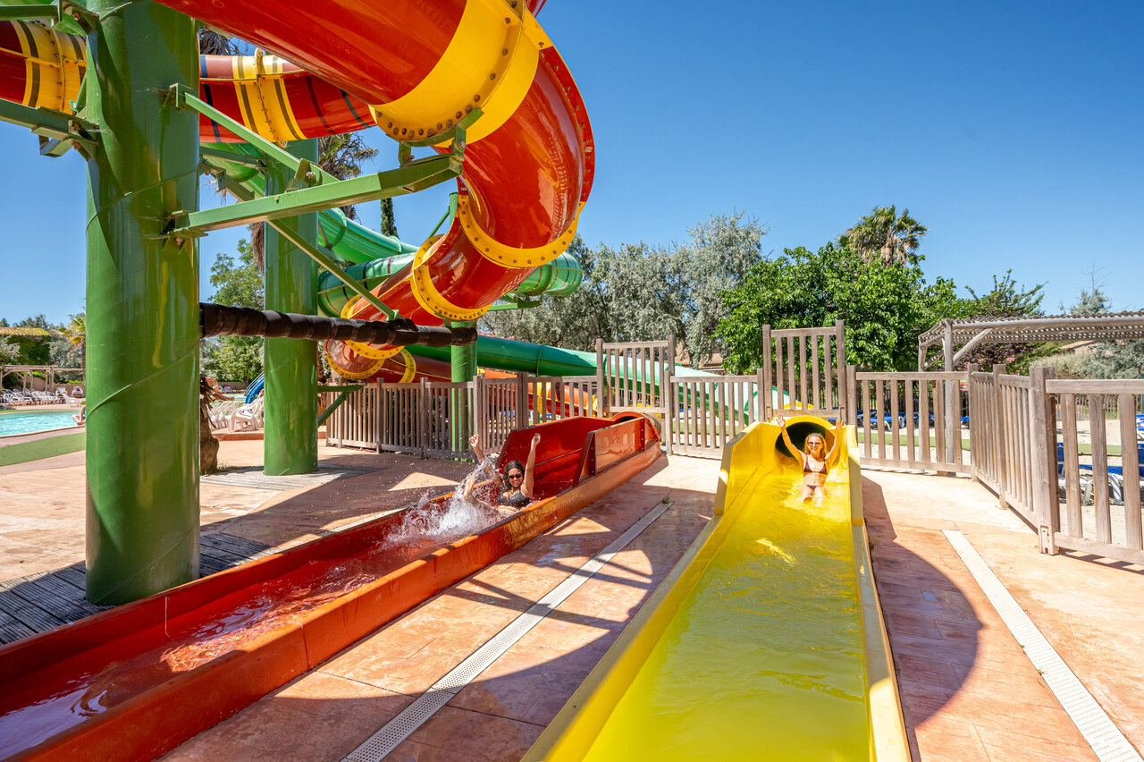 Colorful water slides with guests at CAPFUN Grande Cosse campsite, Saint Pierre la Mer (11).