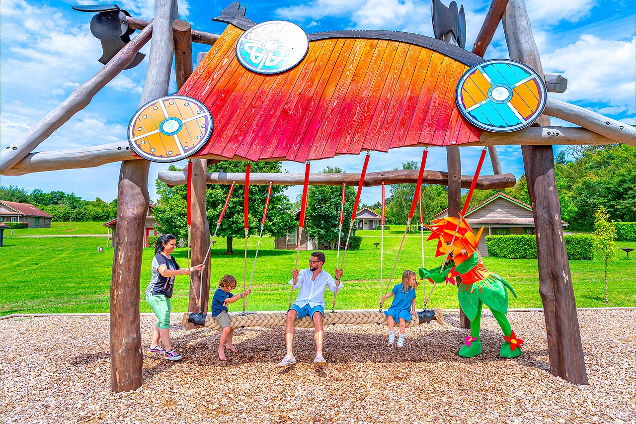 Themed swing, family and mascot at CAPFUN Grand Cerf campsite in Gimouille (58).