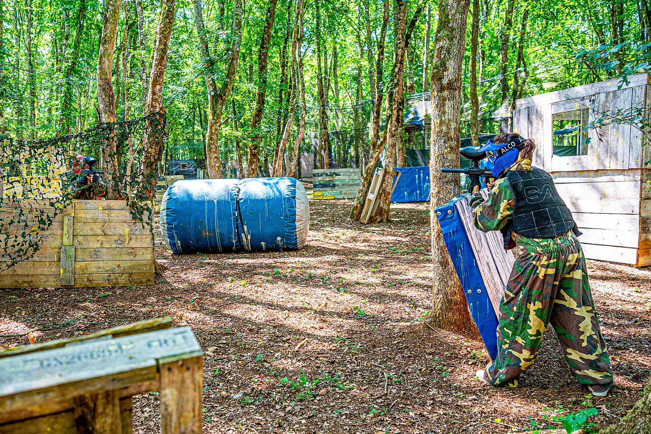 Paintball players in camouflage in a forest, activity at CAPFUN Grand Cerf campsite in Gimouille (58).