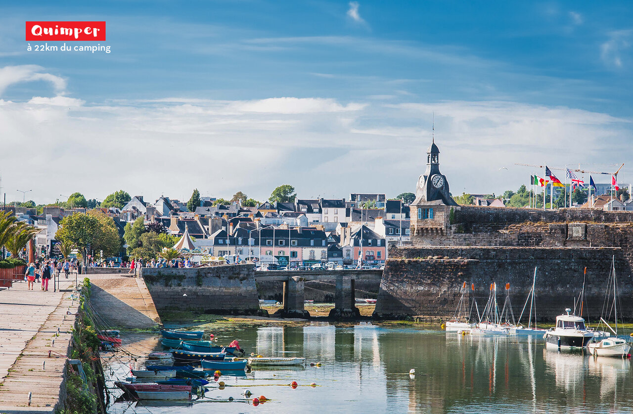 Quimper, historic city in Brittany, port, boats and clock tower.