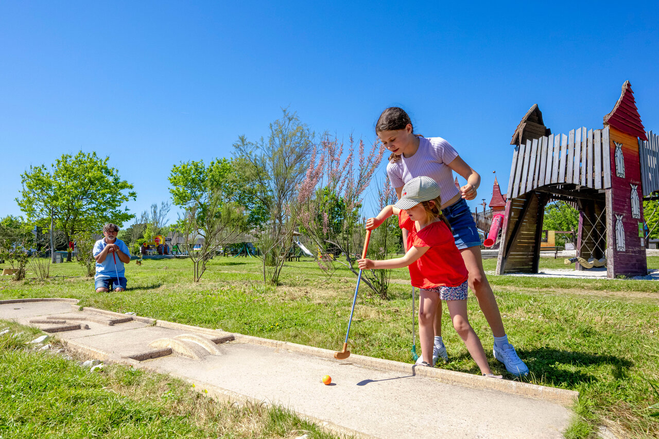 Family mini-golf and playground at CAPFUN Grand Large campsite in FOUESNANT.