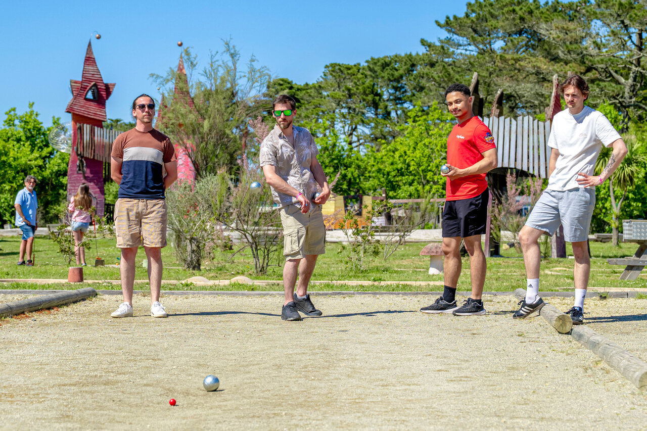 Petanque players on a sunny court at CAPFUN Grand Large campsite in FOUESNANT (29).