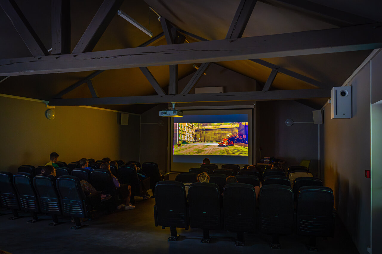 Indoor cinema, giant screen and spectators at CAPFUN Grenouill�re campsite in Su�vres (41).