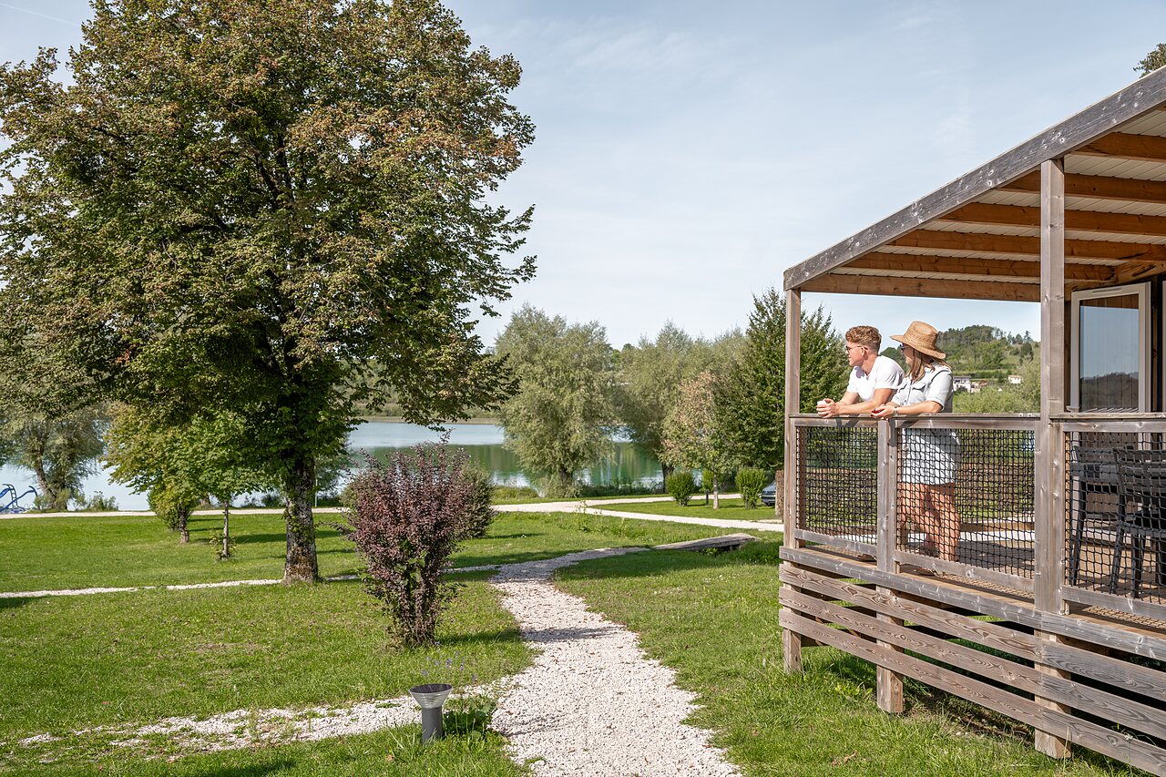 Couple on mobile home terrace, lake view, camping CLICOCHIC Grisi�re, Clairvaux-les-Lacs.