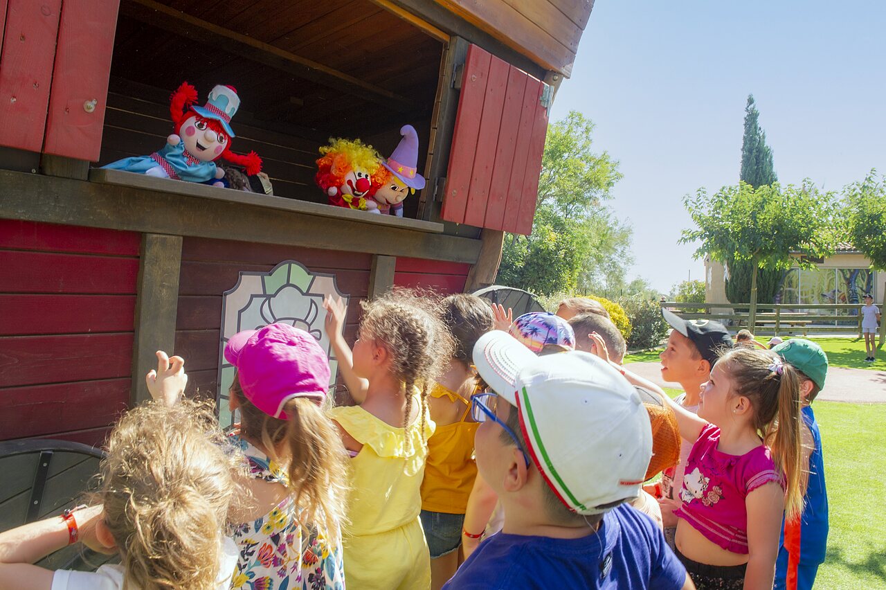 Puppet show for children on outdoor stage at CLICOCHIC Grisi�re campsite.