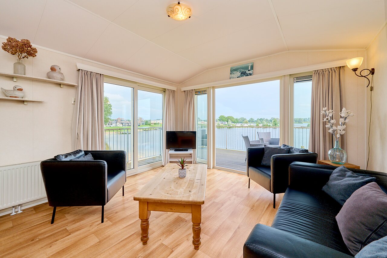 Bright Mobil-home living room, water view at CAPFUN Groene Eiland campsite in Appeltern.