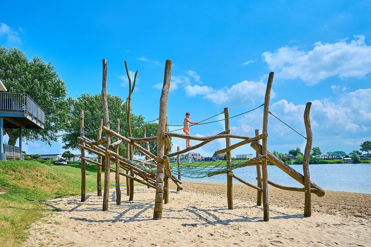 Wooden playground on sandy beach, child, CAPFUN Groene Eiland.