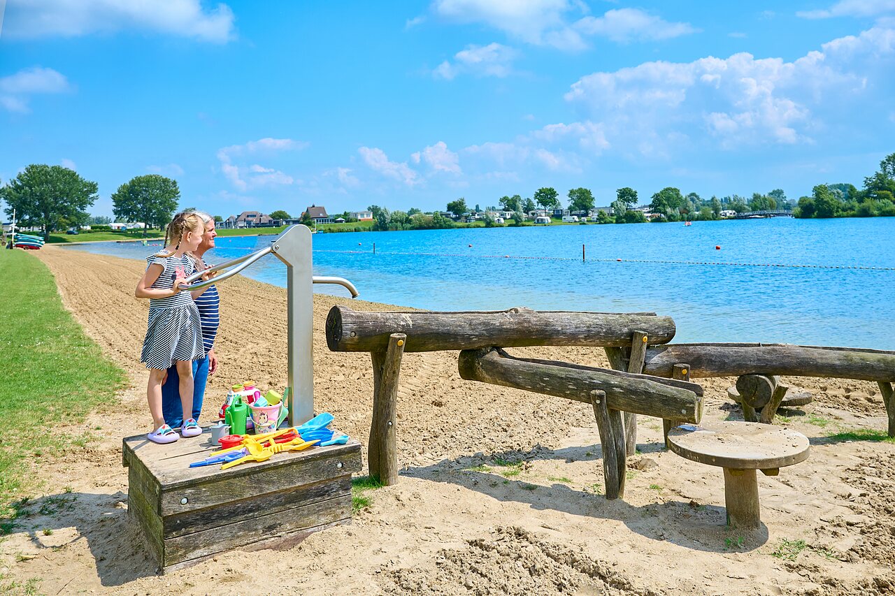 Sandy beach, water games for children at CAPFUN Groene Eiland campsite in Appeltern.
