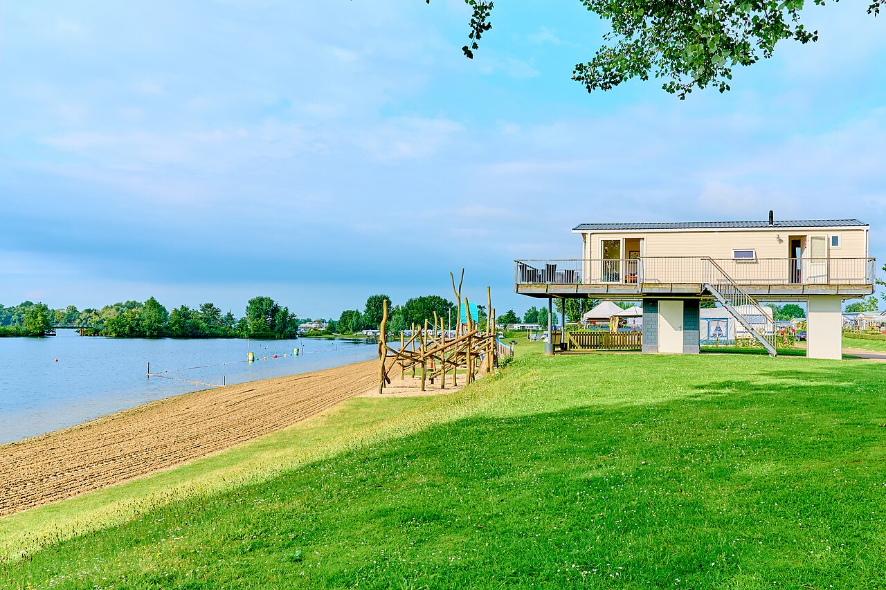 Elevated accommodation and sandy beach at CAPFUN Groene Eiland campsite.