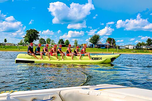 Holidaymakers on banana boat at CAPFUN Groene Eiland campsite in Appeltern.