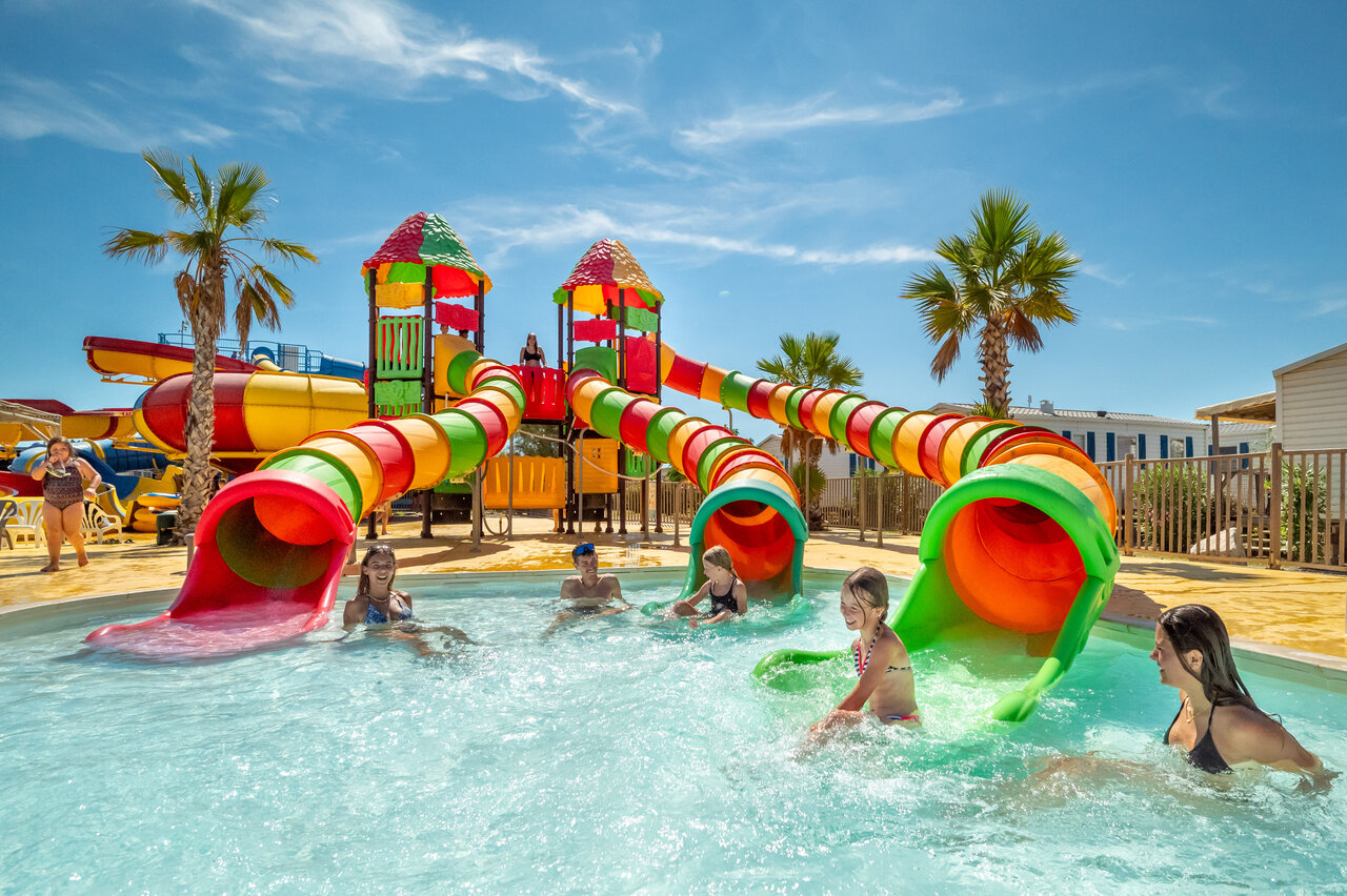 Pool, colorful water slides and children at VAGUES OCEANES Hamacs campsite in Fleury.