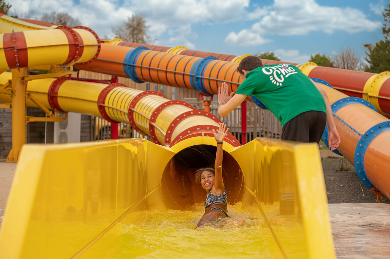 Water slide with child and animator at CLICOCHIC Haras de Deauville campsite in Touques (14).