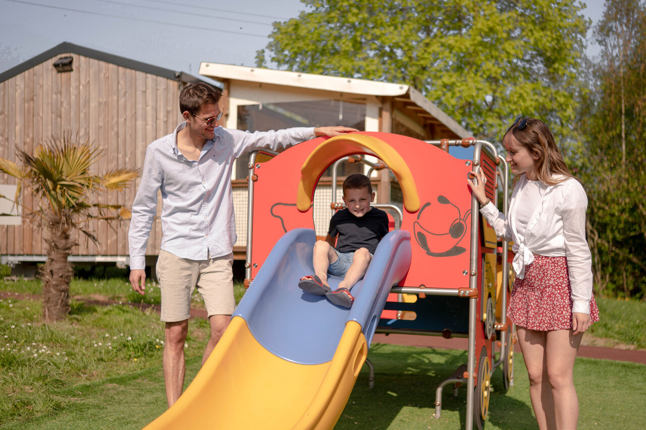 Child on slide, at CLICOCHIC Haras de Deauville campsite in Touques (14).