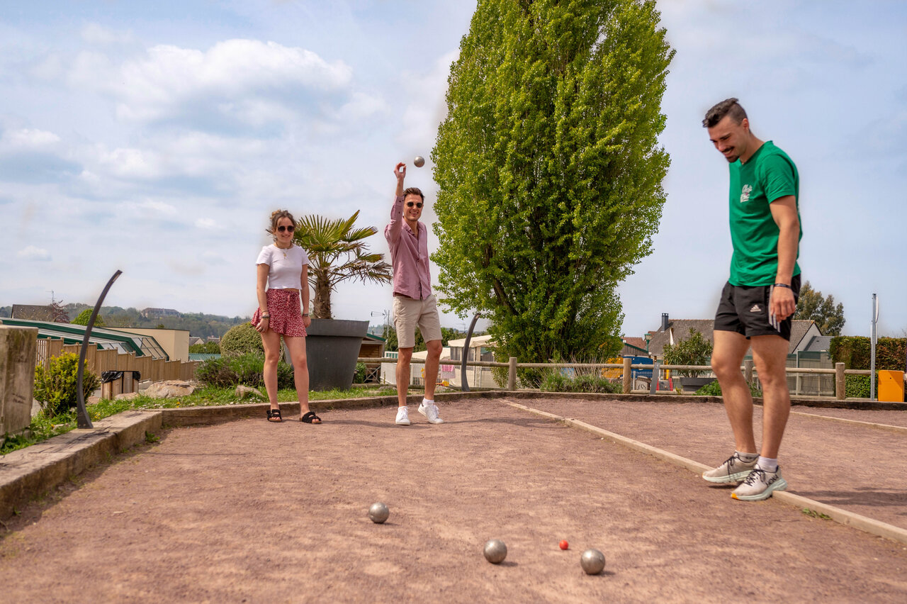 Petanque court with players at CLICOCHIC Haras de Deauville campsite in Touques (14).