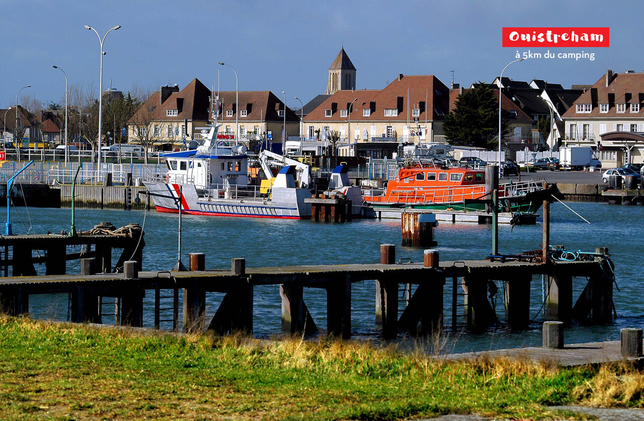 Ouistreham harbor with boats, a charming tourist spot to visit in Normandy.