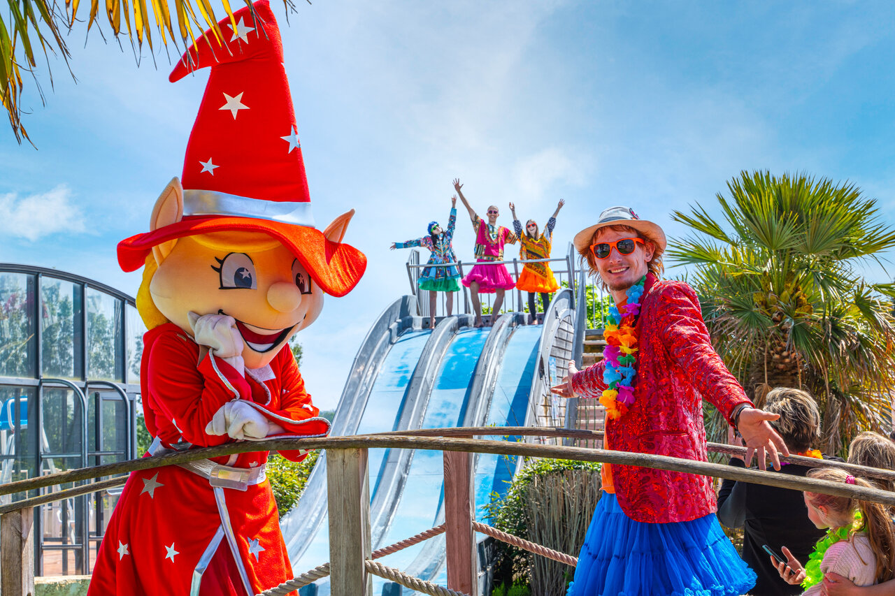 Mascot and cheerful animators near the water slide at CAPFUN Hautes Coutures campsite in BENOUVILLE (14).