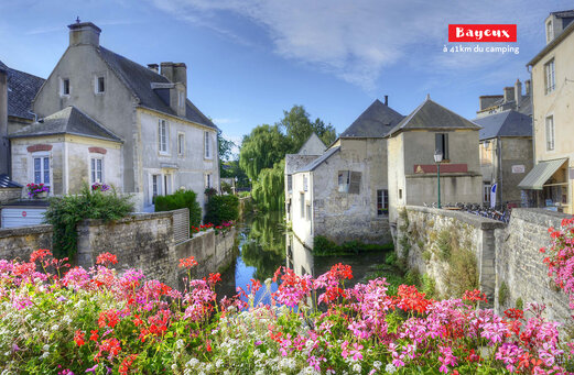 Historic town Bayeux, flowery canal, old houses, charming architecture in Normandy.