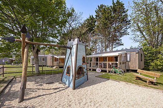 Playground with castle and swing at CLICOCHIC Havre de Berni�res campsite.