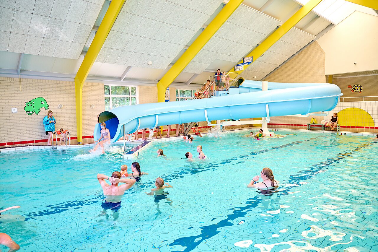 Water slide and lively indoor swimming pool at CAPFUN Heino campsite in Heino.