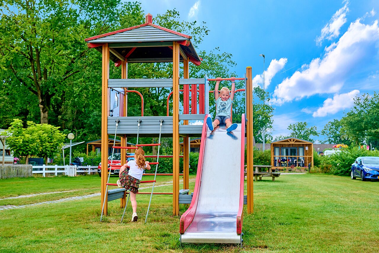 Children on the slide and playground structure at CAPFUN Heino campsite in Heino.