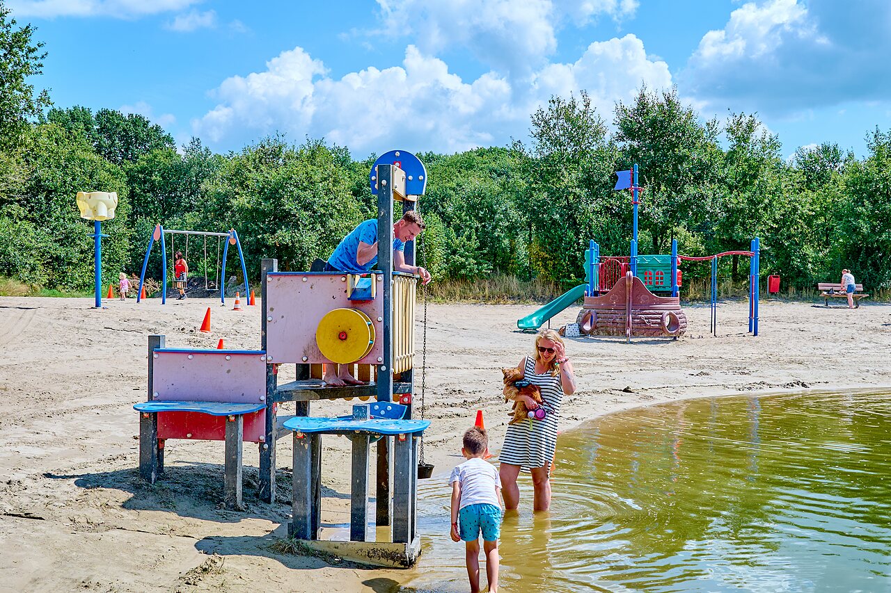 Water playground and sandy beach with structures at CAPFUN Heino campsite in Heino.