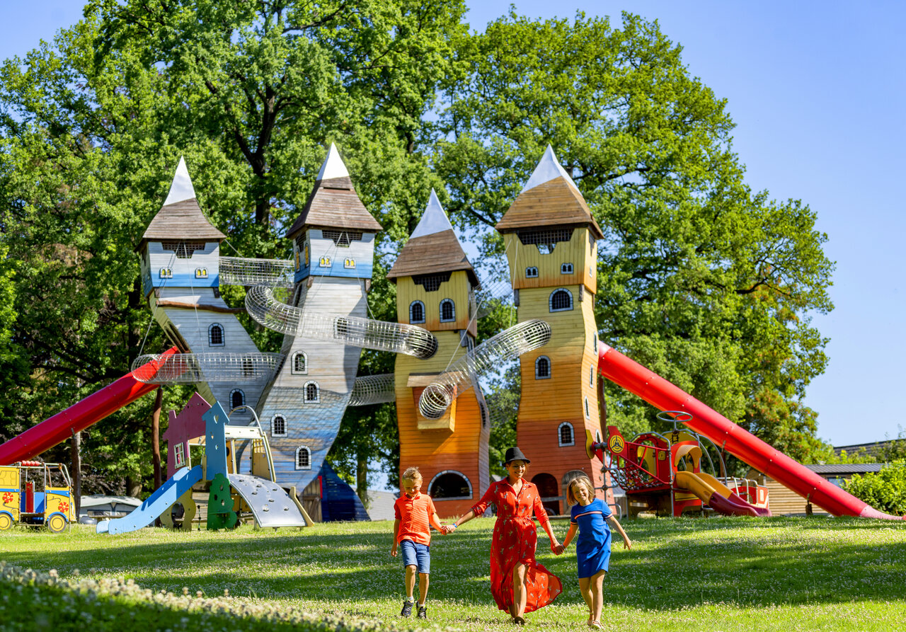 Large castle playground with slides and family at CAPFUN Hirondelle campsite in Oteppe.