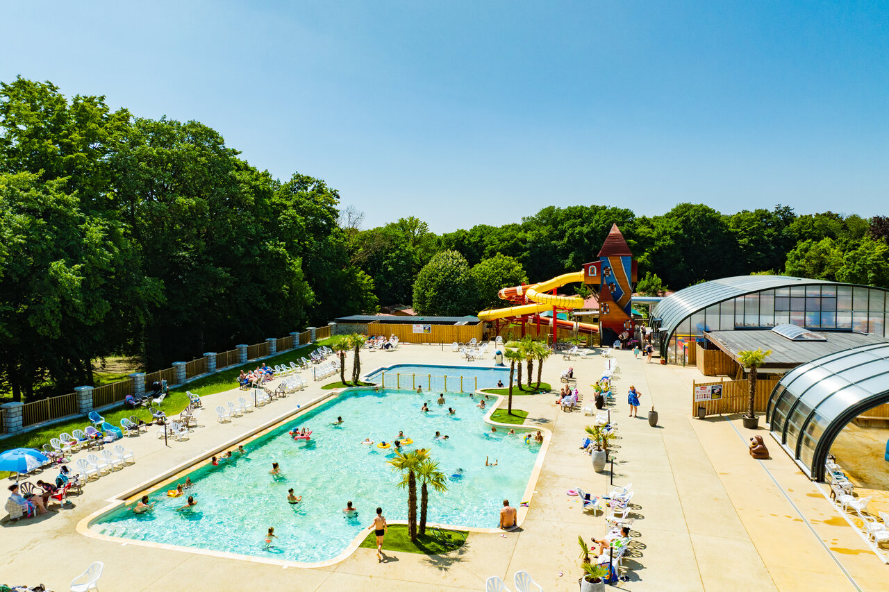 Outdoor pool, water slides and play area at CAPFUN Hirondelle campsite in Oteppe.