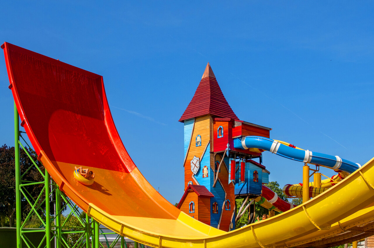 Giant water slide and colorful play tower at CAPFUN Hirondelle campsite in Oteppe.