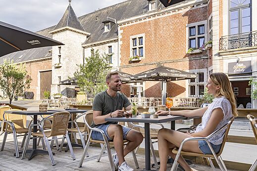 Lively terrace of Oteppe Castle, historic place to visit near the campsite.