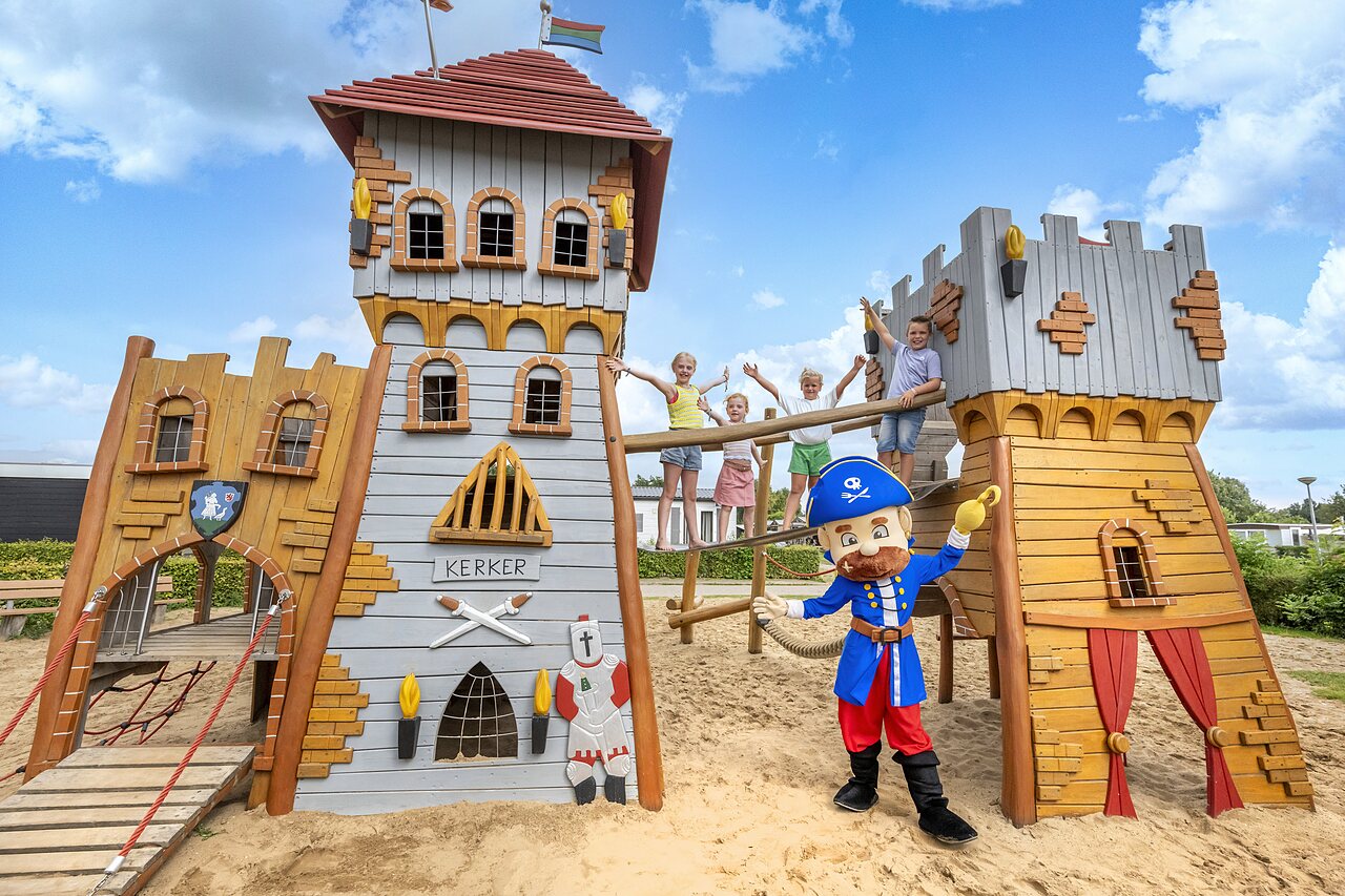Castle playground, children, and pirate mascot at CAPFUN IJsselstrand campsite in Doesburg.