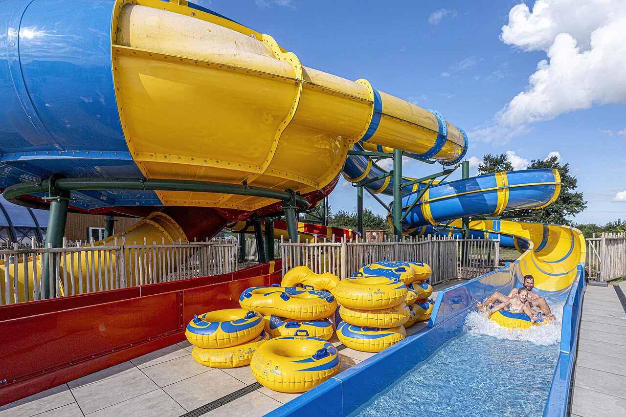Giant water slides and people on rings at CAPFUN IJsselstrand campsite in Doesburg.