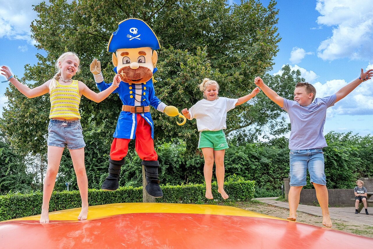 Children and pirate mascot on bouncy cushion at CAPFUN IJsselstrand campsite in Doesburg
