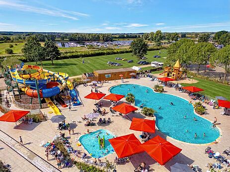 Colorful water slides and outdoor pools at CAPFUN IJsselstrand campsite in Doesburg.