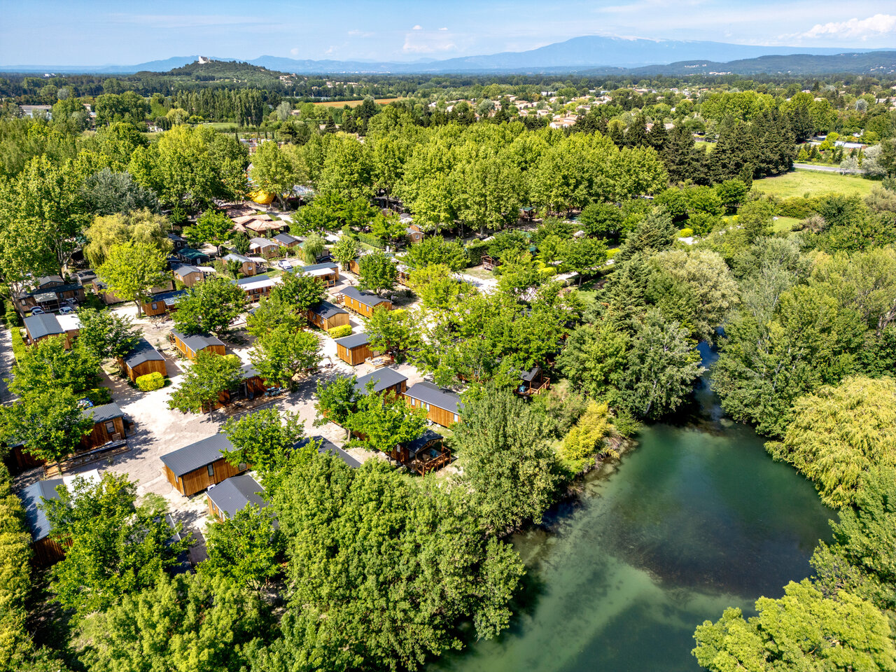 Aerial view of campsite with mobile homes and river at CAPFUN Jantou in LE THOR (84).