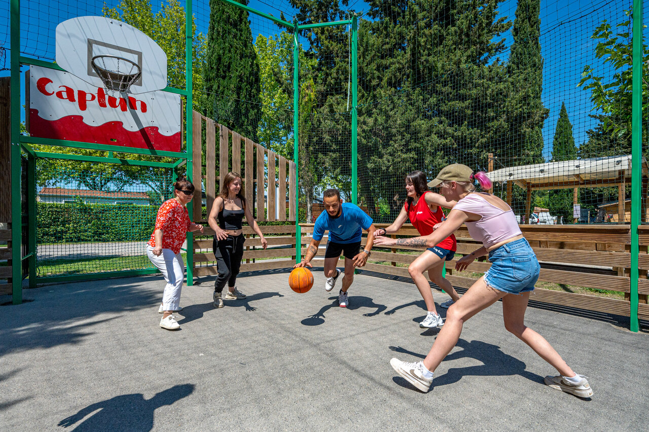 Basketball game on multisport court at CAPFUN Jantou campsite in LE THOR.