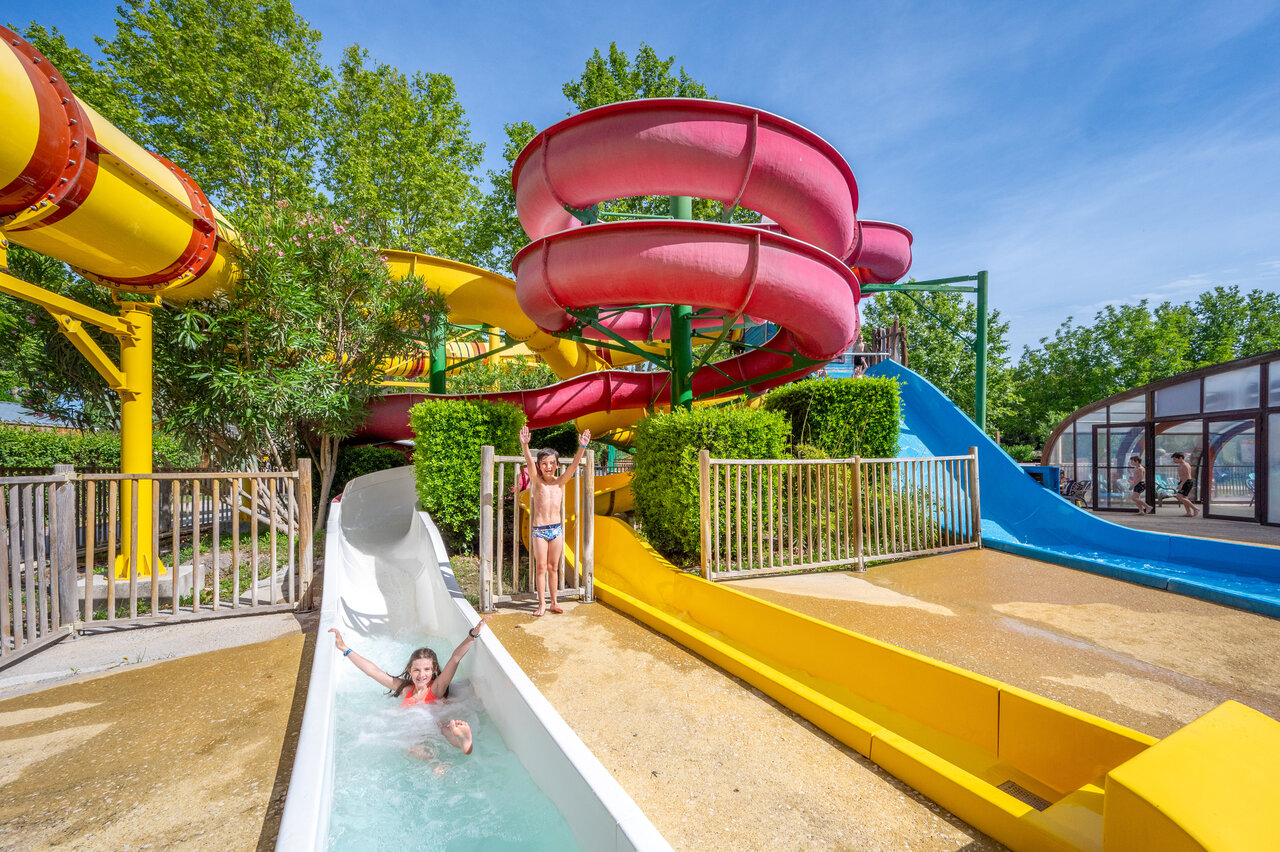 Colorful water slides, children having fun at CAPFUN Jantou campsite in LE THOR (84).