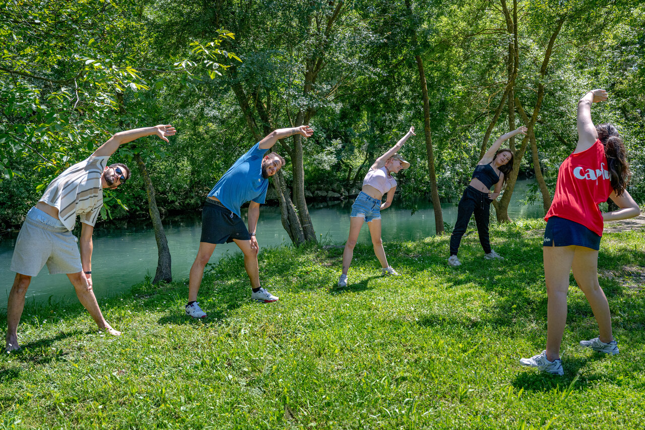Group stretching in nature at CAPFUN Jantou campsite in LE THOR (84).