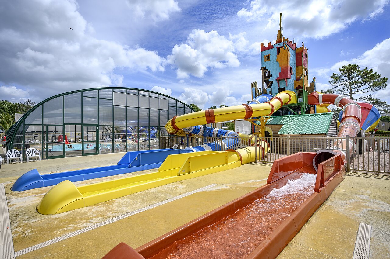 Colorful water slides and indoor swimming pool at CAPFUN Joncal campsite in Grandcamp - Maisy (14).