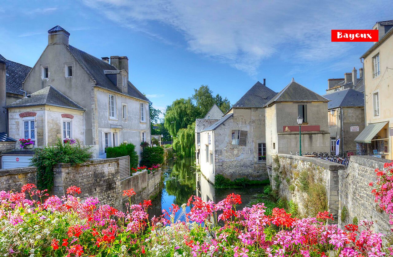 Historic city of Bayeux with river and old flowery houses in Normandy.