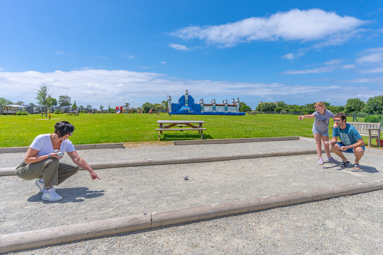Family playing p�tanque, bouncy castle at CAPFUN Kervel campsite (29).