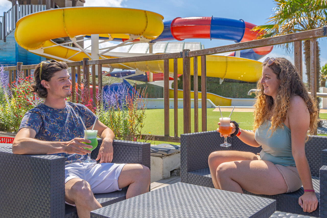 Couple with cocktails, water slides at CAPFUN Kervel in PLONEVEZ PORZAY (29).