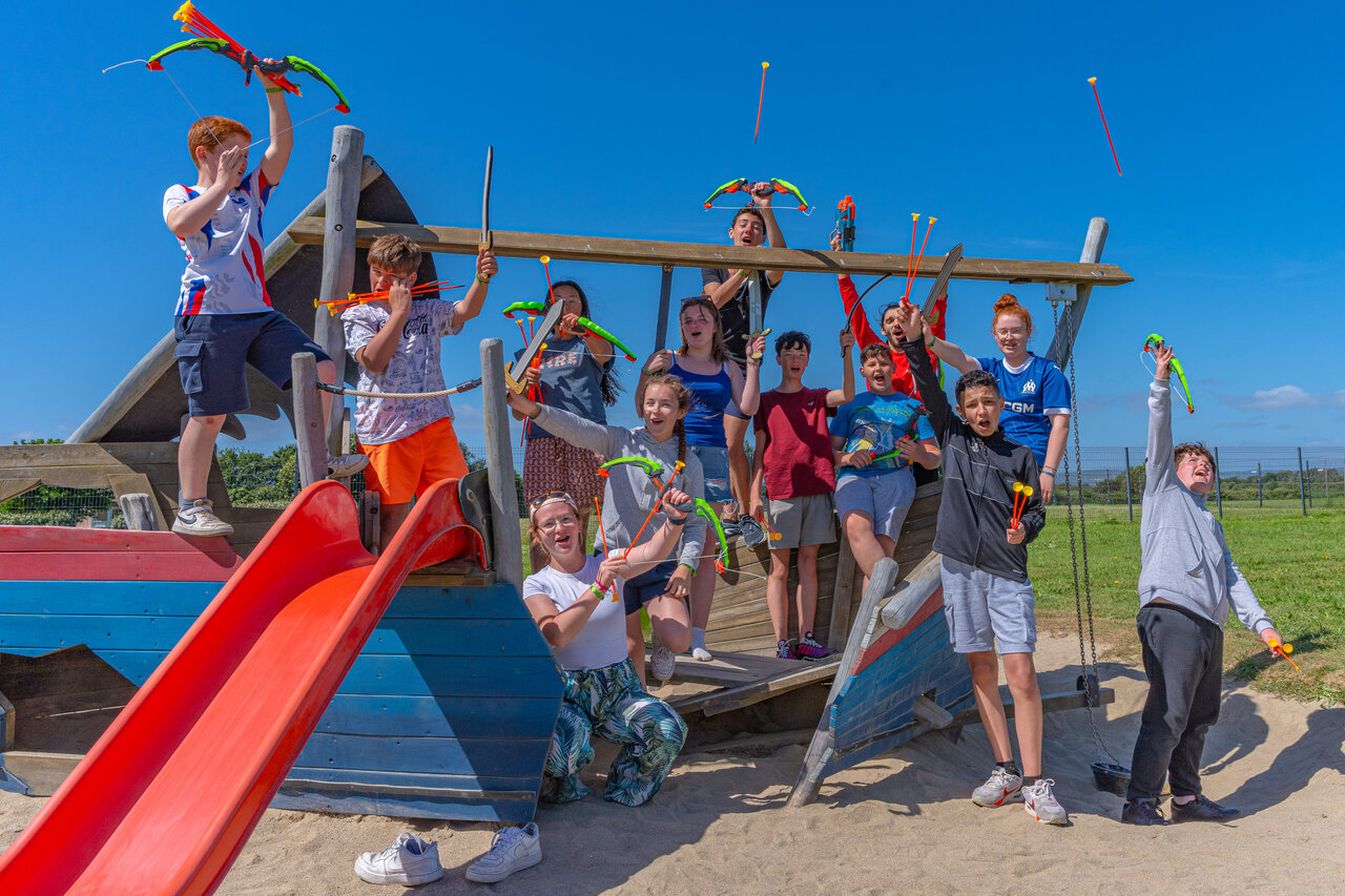 Children playing with bows and swords on boat playground at CAPFUN Kervel campsite in PLONEVEZ PORZAY (29).