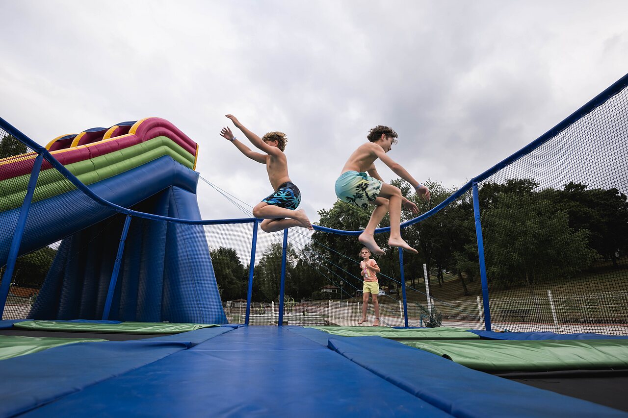Kids jumping on trampoline and inflatable games at CAPFUN Lac des 3 Vall�es, Lectoure.