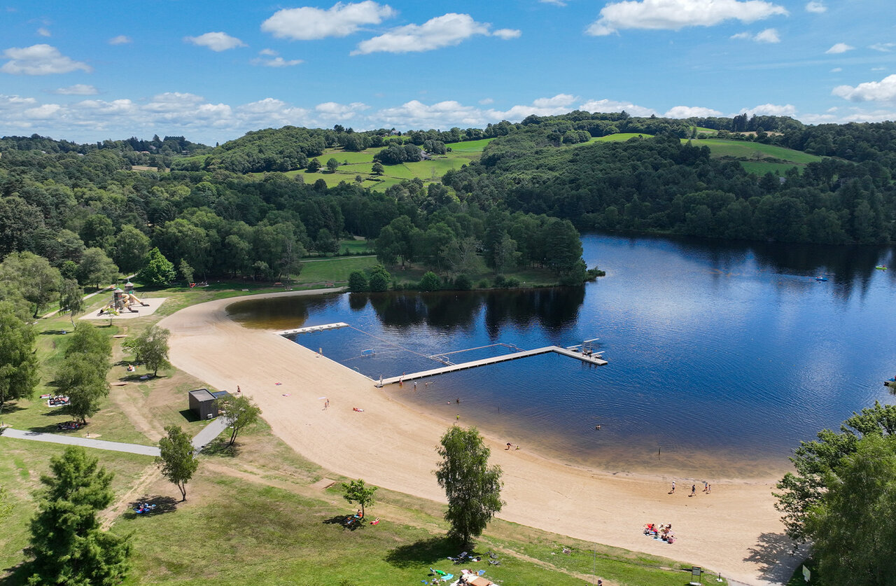 Sandy beach, equipped lake and children's playground at CLICOCHIC Lac de Miel campsite in Beynat (19).