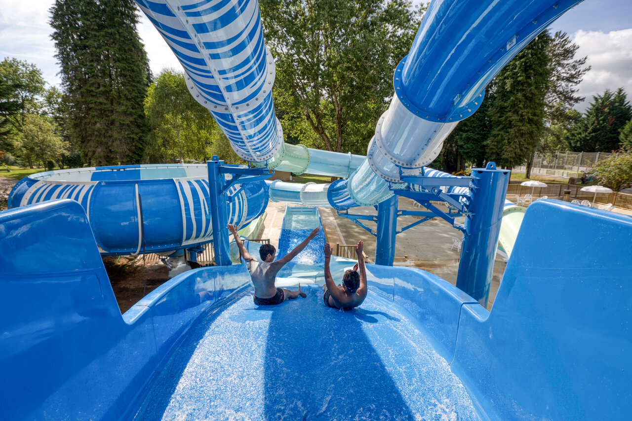 Blue water slides, children at CLICOCHIC Lac de Miel campsite in Beynat (19).
