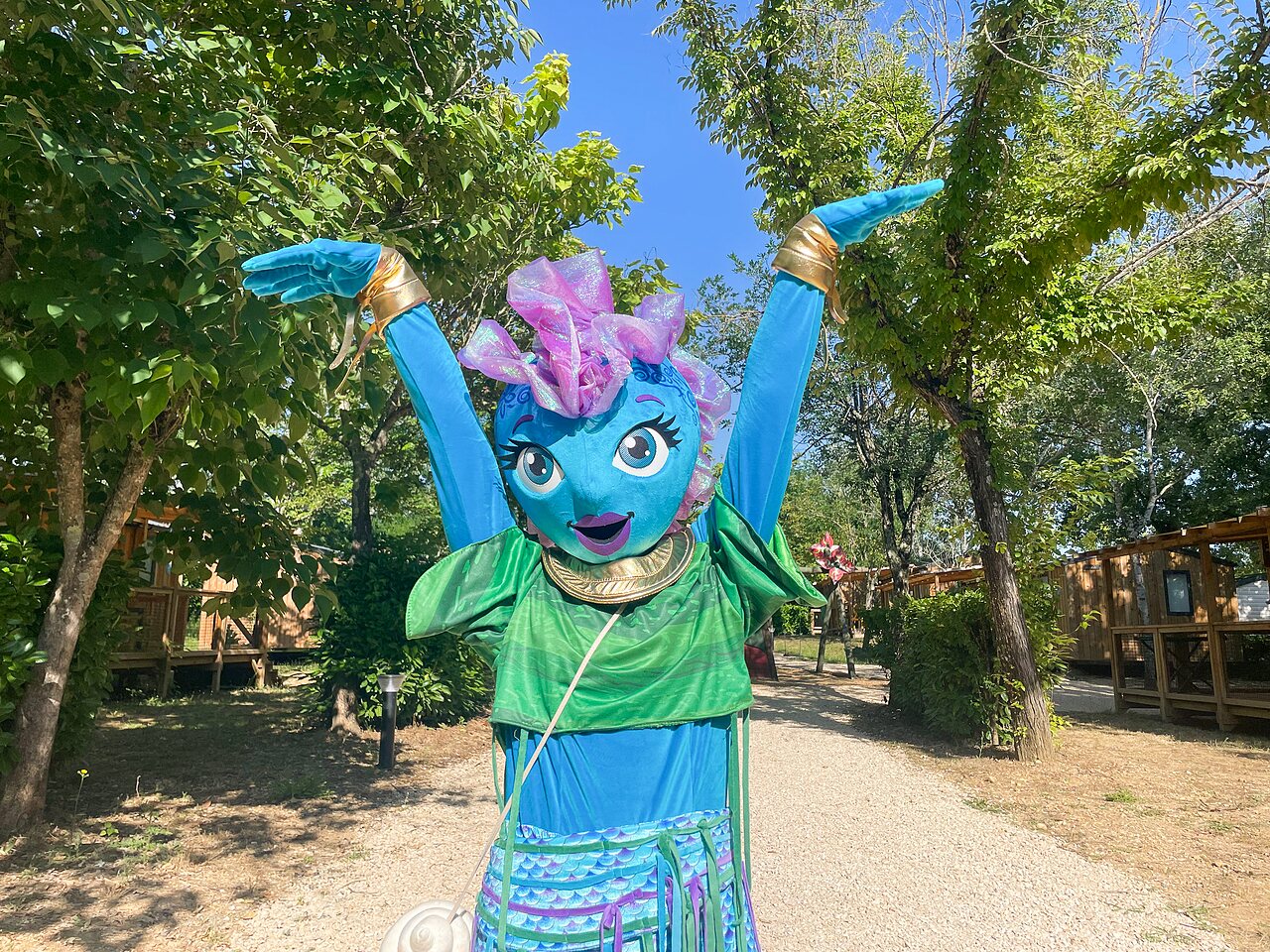Cheerful blue mascot in the alleys at VAGUES OCEANES Lac de Panthier campsite in Vandenesse-en-Auxois (21).