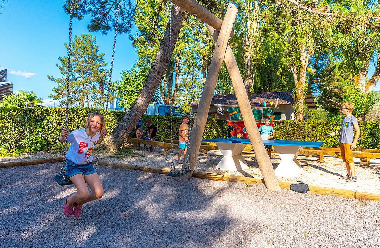 Children on swing and ping-pong at VAGUES OCEANES campsite in Vandenesse-en-Auxois.