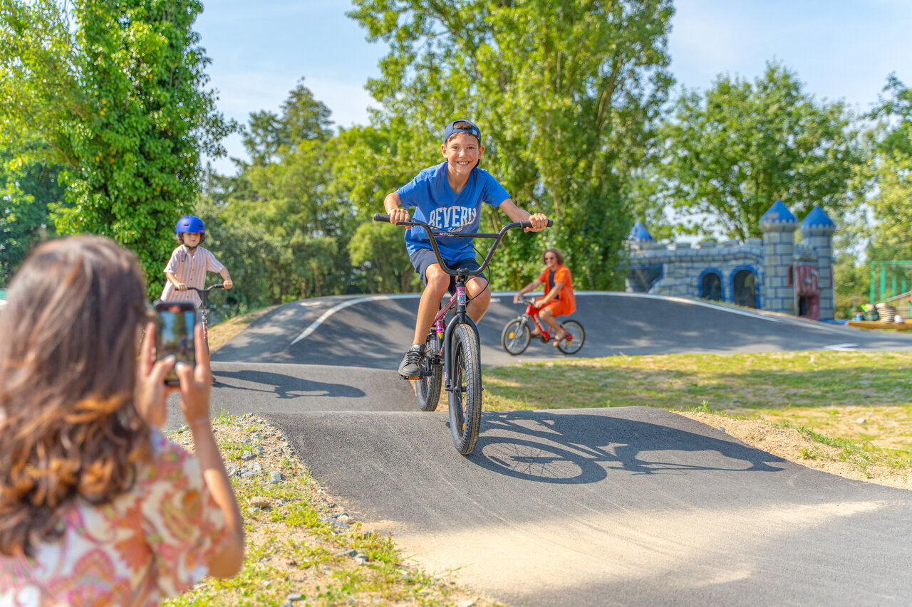 Children on pump track, CAPFUN Lac de Ribou campsite, Cholet (49).